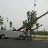 INT-60 heavy duty integrated wrecker operating telescopic boom on a roadway