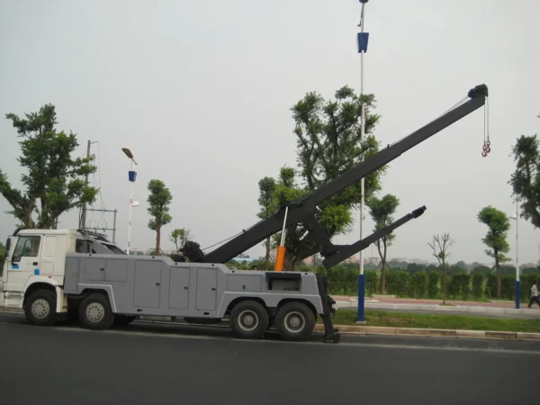 INT-60 heavy duty integrated wrecker operating telescopic boom on a roadway