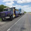 INT-60 heavy duty integrated wrecker towing a tractor-trailer combination on the highway
