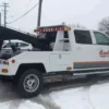 Metro Tow Trucks INT-5 white side view during recovery operation in winter
