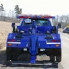 Metro Tow Trucks INT-5 blue wheel-lift fully extended on gravel road