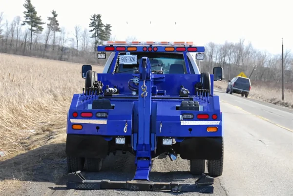Metro Tow Trucks INT-5 blue wheel-lift fully extended on gravel road