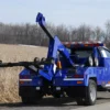Metro Tow Trucks INT-5 blue integrated tow truck rear angled view with wheel-lift extended
