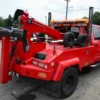 Metro Tow Trucks INT-5 red recovery unit rear side detail with wheel-lift cylinders visible