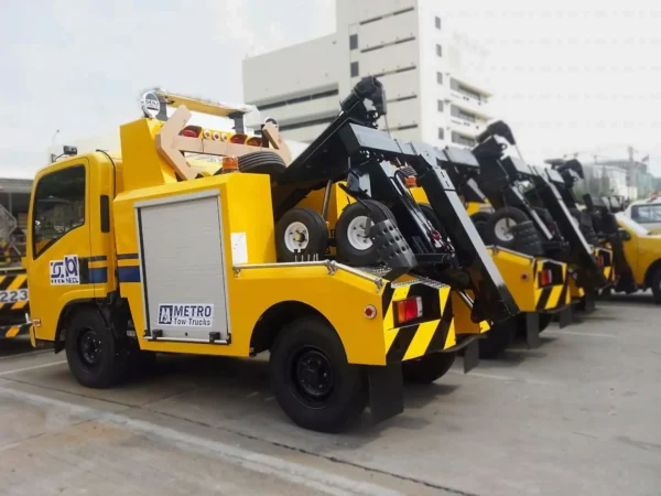 Yellow INT-5 integrated wrecker angled roadside view