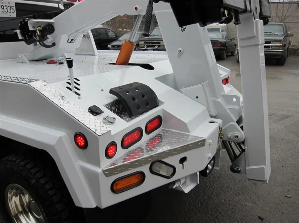 Metro Tow Trucks INT-5 white wheel-lift arm close-up folded position