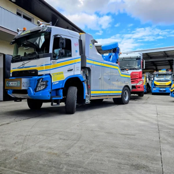 Metro Tow Trucks INT-30 heavy-duty integrated wrecker left side profile with blue boom parked outdoors