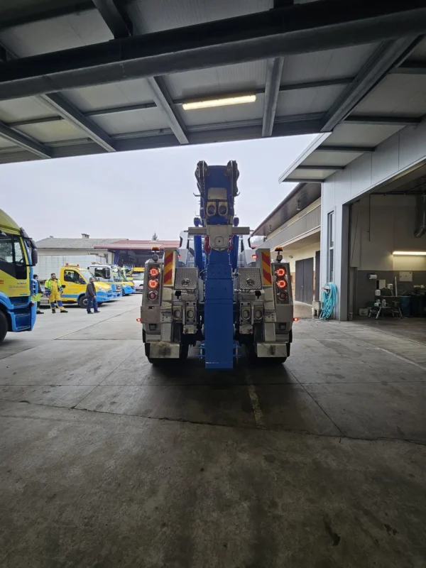 Metro Tow Trucks INT-30 heavy-duty integrated wrecker rear view centered in workshop driveway