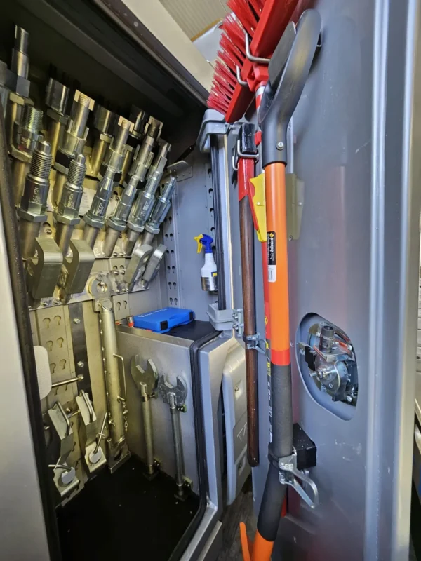 Metro Tow Trucks INT-30 equipment storage compartment open showing towing accessories and tools