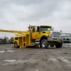 Metro RTR-16 rotator recovery truck with raised boom in construction site environment