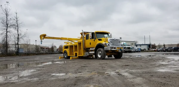 Metro RTR-16 rotator recovery truck with raised boom in construction site environment