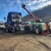 Metro RTR-16 rotator heavy wrecker recovering a tractor truck at roadside slope