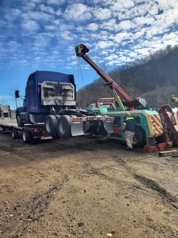 Metro RTR-16 rotator heavy wrecker recovering a tractor truck at roadside slope