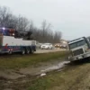 Metro Tow Trucks RTR-35 rotator winching overturned vehicle from muddy roadside