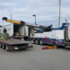 Metro Tow Trucks RTR-35 rotator assisting flatbed loading during roadside recovery