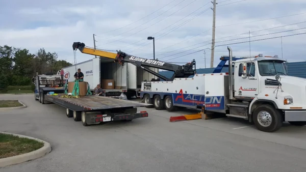 Metro Tow Trucks RTR-35 rotator assisting flatbed loading during roadside recovery