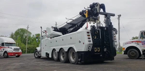 Metro Tow Trucks RTR-50 rotator parked on recovery site with boom secured and outriggers retracted
