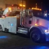 Metro Tow Trucks RTR-50 rotator at night scene with emergency lights activated during roadside service