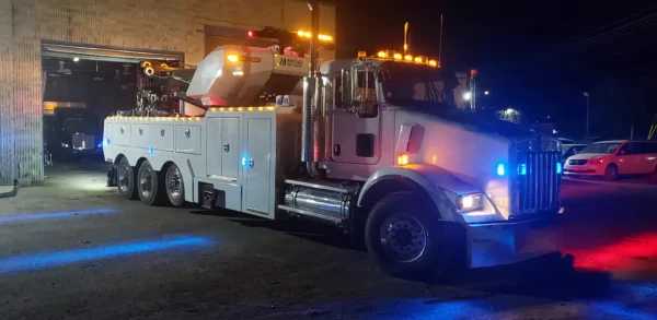 Metro Tow Trucks RTR-50 rotator at night scene with emergency lights activated during roadside service