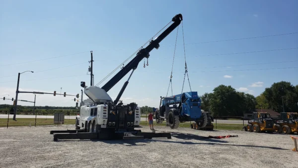 Metro Tow Trucks RTR-50 rotator lifting a disabled vehicle using boom and winch at intersection recovery