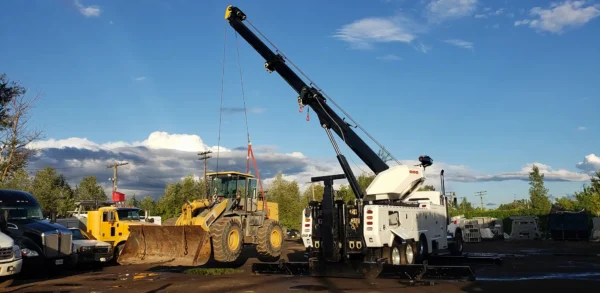 Metro Tow Trucks RTR-50 rotator recovering heavy equipment with boom and winches at roadside job