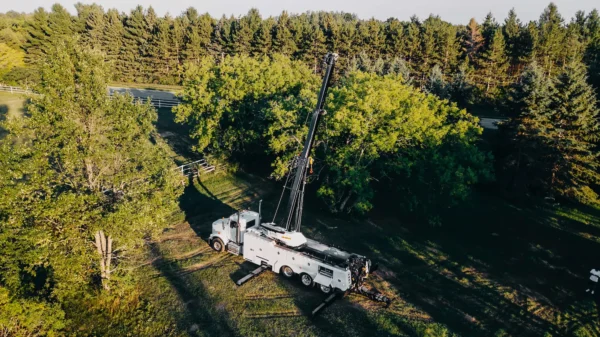 Metro Tow Trucks RTR-50 rotator performing off-road recovery in wooded terrain with extended boom