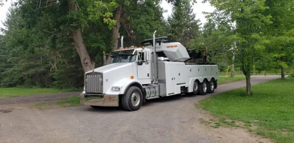 Metro Tow Trucks RTR-50 heavy-duty rotator tow truck positioned in a grassy rural area