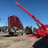 Metro Tow Trucks RTR-50 rotator recovering a disabled semi-truck using extended boom on job site