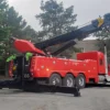 Metro Tow Trucks RTR-50 red rotator wrecker lifting operation with rear outriggers deployed