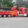 Metro Tow Trucks RTR-50 red heavy rotator wrecker parked roadside — recovery boom folded