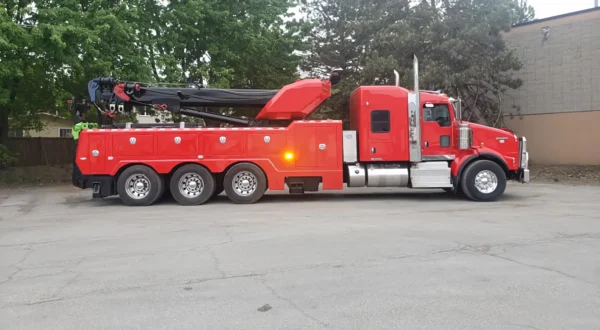Metro Tow Trucks RTR-50 red heavy rotator wrecker parked roadside — recovery boom folded