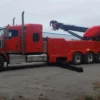 Metro Tow Trucks RTR-50 red rotator wrecker deploying outriggers for heavy vehicle lifting