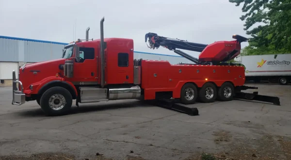 Metro Tow Trucks RTR-50 red rotator wrecker deploying outriggers for heavy vehicle lifting