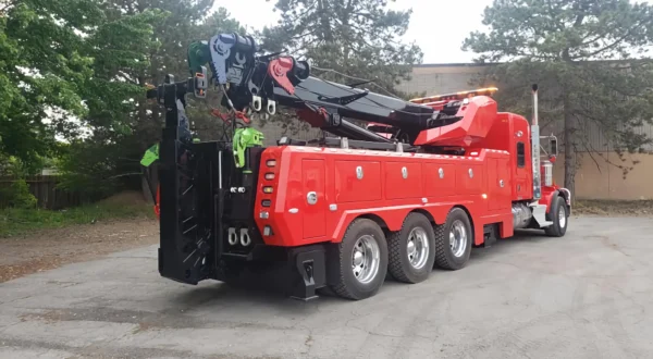 Metro Tow Trucks RTR-50 red heavy rotator tow truck with extended outriggers ready for lifting