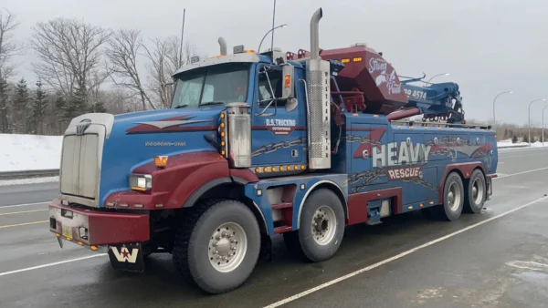 Metro Tow Trucks RTR-50 rotator tow truck on snowy roadside ready for heavy vehicle recovery