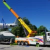Metro RTR-70 heavy-duty rotator boom lifting aircraft from a flatbed trailer