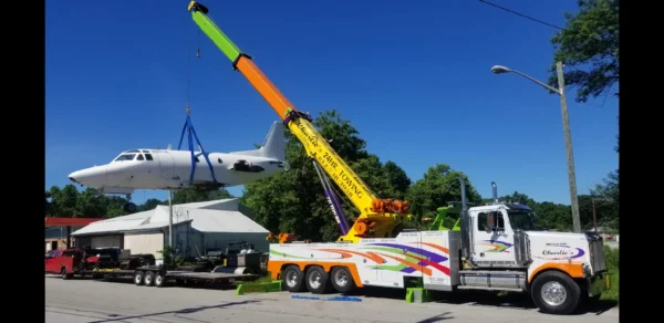 Metro RTR-70 heavy-duty rotator boom lifting aircraft from a flatbed trailer