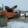 Metro RTR-70 heavy rotator operating in snowy terrain during heavy equipment recovery