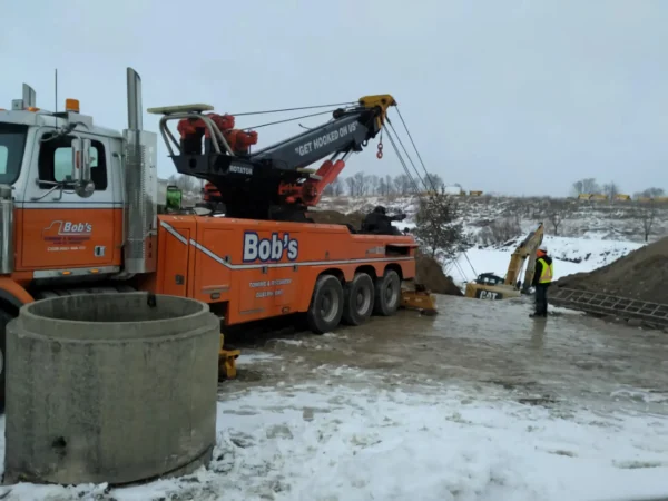 Metro RTR-70 heavy rotator operating in snowy terrain during heavy equipment recovery