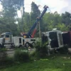 Metro RTR-70 rotator recovering an overturned truck from roadside ditch in emergency scene