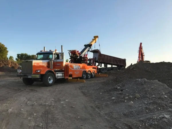 Metro RTR-70 rotator lifting a dump body at sand and gravel pit