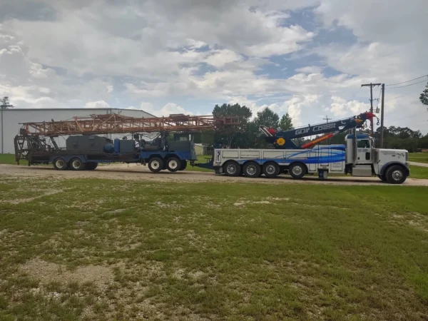Metro RTR-70 70-ton rotator towing logging truck during off-road recovery