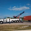 Metro RTR-70 70-ton heavy rotator lifting shipping containers on highway