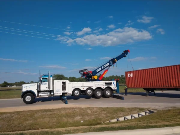 Metro RTR-70 70-ton heavy rotator lifting shipping containers on highway