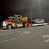 TSA-50 trailer hauling equipment at night, shown under street lighting on a highway ramp