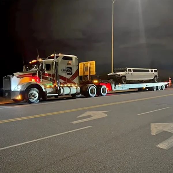 TSA-50 trailer hauling equipment at night, shown under street lighting on a highway ramp