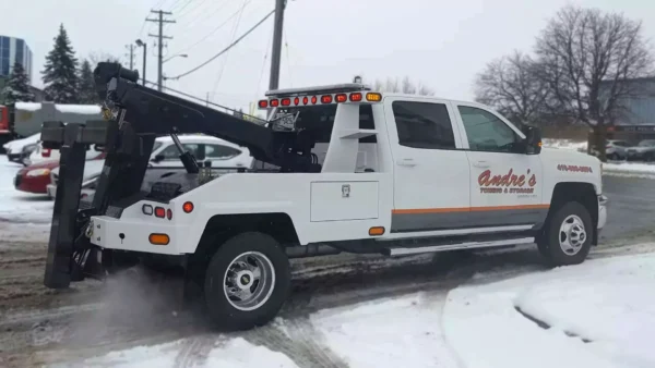 Metro INT-5 integrated wrecker in winter, side view white truck
