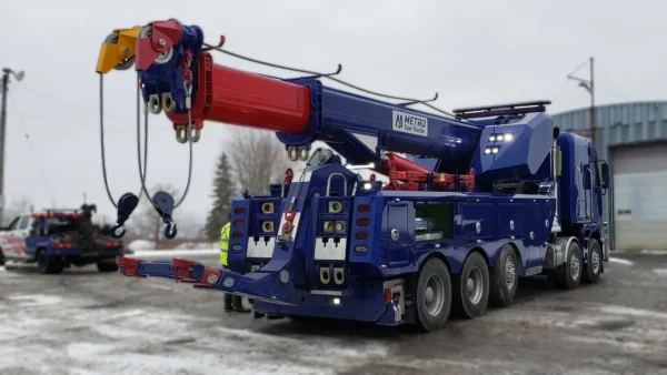 Metro Heavy Recovery 70 blue wrecker performing heavy lift with boom setup