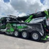 IND-60 heavy-duty independent wrecker parked roadside, showing multi-axle configuration and extended boom
