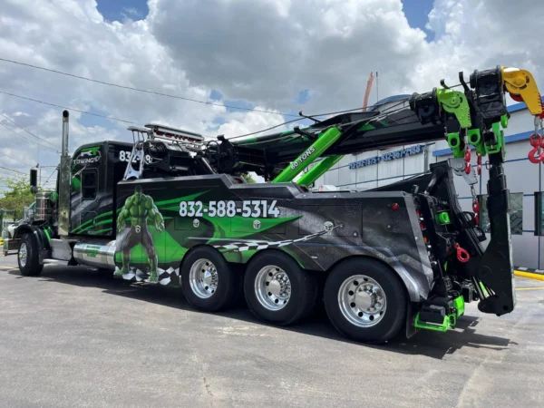 IND-60 heavy-duty independent wrecker parked roadside, showing multi-axle configuration and extended boom